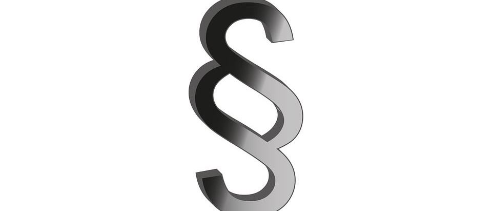 Ein großes, metallisches Symbol eines '&' Zeichens ist auf einem weißen Hintergrund abgebildet.