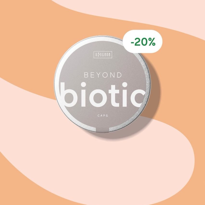 Runde metallische Dose mit der Aufschrift 'Beyond Biotic Caps' und einem 20% Rabatt-Tag auf einem pfirsichfarbenen Hintergrund.