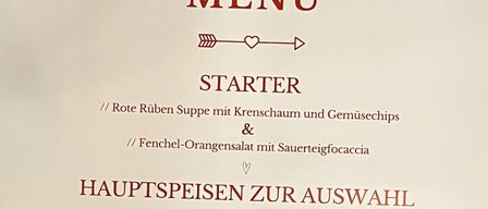 Valentinstagsmenü mit roter Suppe, Fenchel-Orangensalat und drei Hauptgerichten: Salt Beef Burger, panierter Lachs oder Rosa Ravioli. Dessert ist nicht erwähnt.