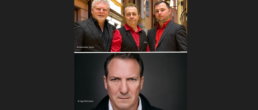 Drei Männer in schwarzen und roten Hemden posieren zusammen vor einem Gebäude. Darunter steht ein Mann, der nach vorne schaut, sein Gesicht beleuchtet.