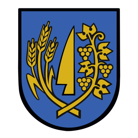 Das Bild zeigt ein schildförmiges Emblem mit blauem Hintergrund. Es enthält Weizenähren und ein goldenes Blattdesign.