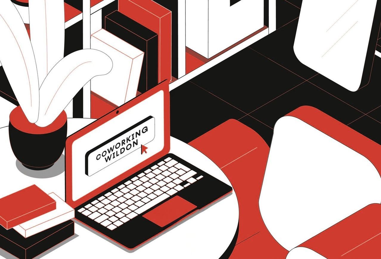 An illustration shows a laptop open on a table with the text 'COWORKING WILDON' on the screen, set in a minimalist, red and black design workspace.