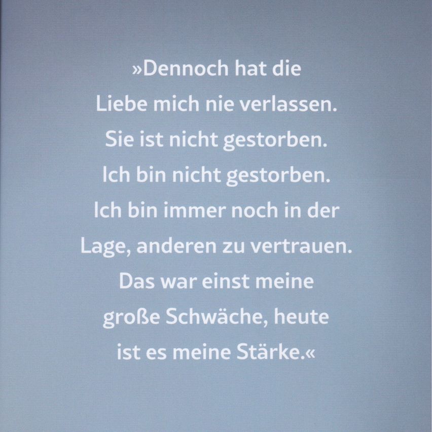 A blue background displays a quote in white text: 'Love has never left me. It is not dead. I am not dead. I am always still in the position to trust others. That was once my great weakness, now it is my strength.'