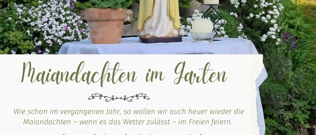 Ein Garten mit Blumen, einer Statue und einem Tisch mit Kerzen. Maiandachten im Garten. 7. Mai, 18 Uhr, Kirchenpark. 21. Mai, 19 Uhr, bei Fam. Kerschbaumer, W. A. Mozartgasse 17.