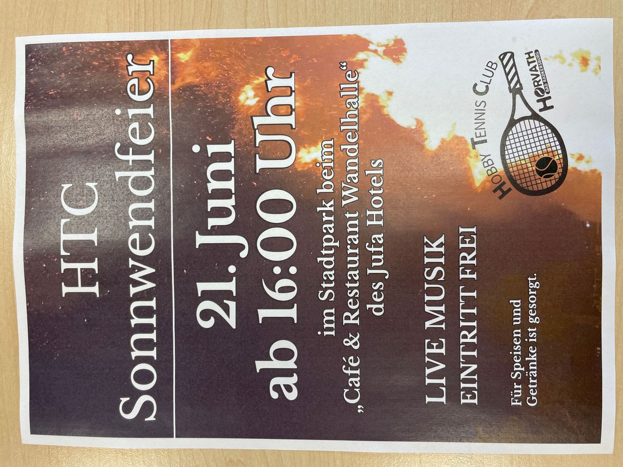 Poster with a fiery background advertising a June 21 event starting at 16:00. It mentions free entrance, live music, and a cafe. It's sponsored by Tennis Club Hobby and features a tennis racket logo.