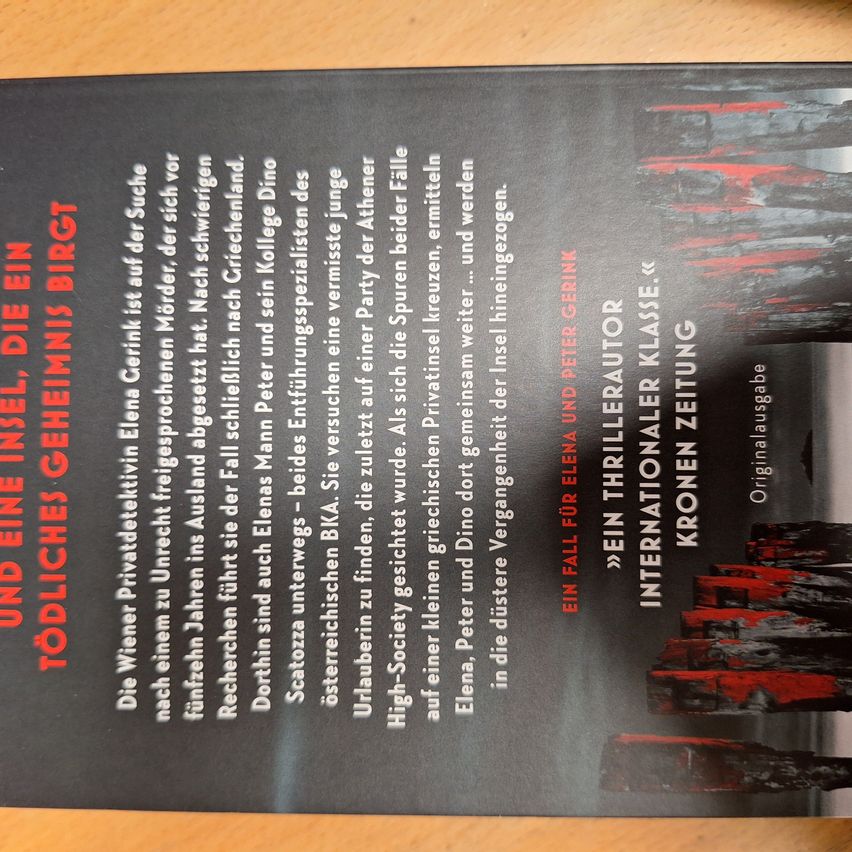 The back cover of a book with a black background and white text. It contains titles, names, and possibly a summary. The titles are in bold red, white, and black fonts. The names are in white font. The summary is in white font. The cover is blurry.