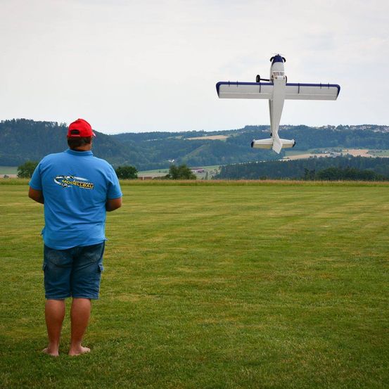 Image contains, Grass, T-Shirt, Cross, Shorts, Flying, Person, Portrait, Airport, Adult, Man