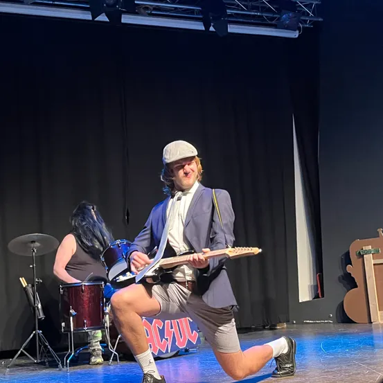 Stage, Adult, Female, Person, Woman, Male, Man, Solo Performance, Guitar, Jeans