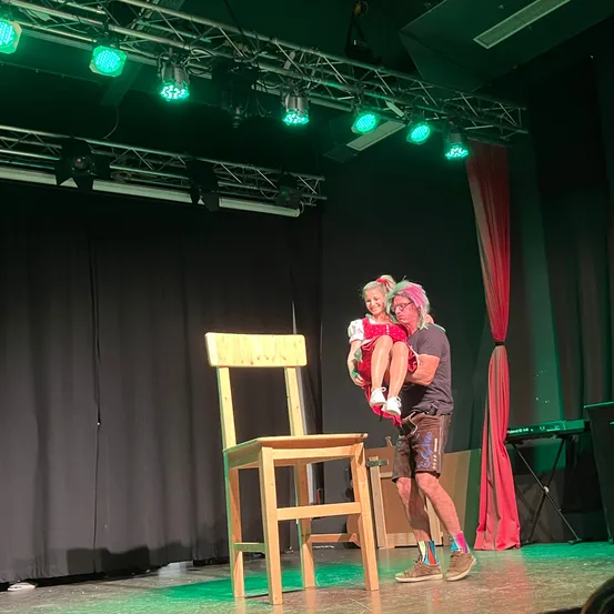 Stage, Performer, Person, Solo Performance, Lighting, Chair, Floor, Dancing, Shoe, Face