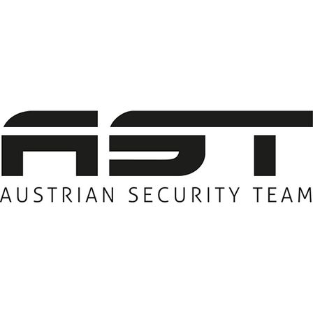 Das Logo des österreichischen Sicherheitsteams mit stilisierten Buchstaben AST in fetter schwarzer Schrift, darunter steht 'AUSTRIAN SECURITY TEAM' in kleinerer Schrift.