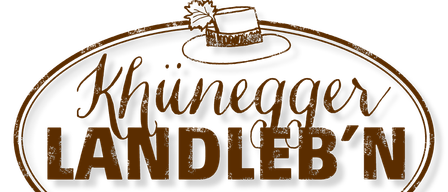 Das Logo von Khiunegger Candle zeigt einen braunen Hut mit einem Blatt oben, vor einem schwarzen Hintergrund mit goldenen Verzierungen.