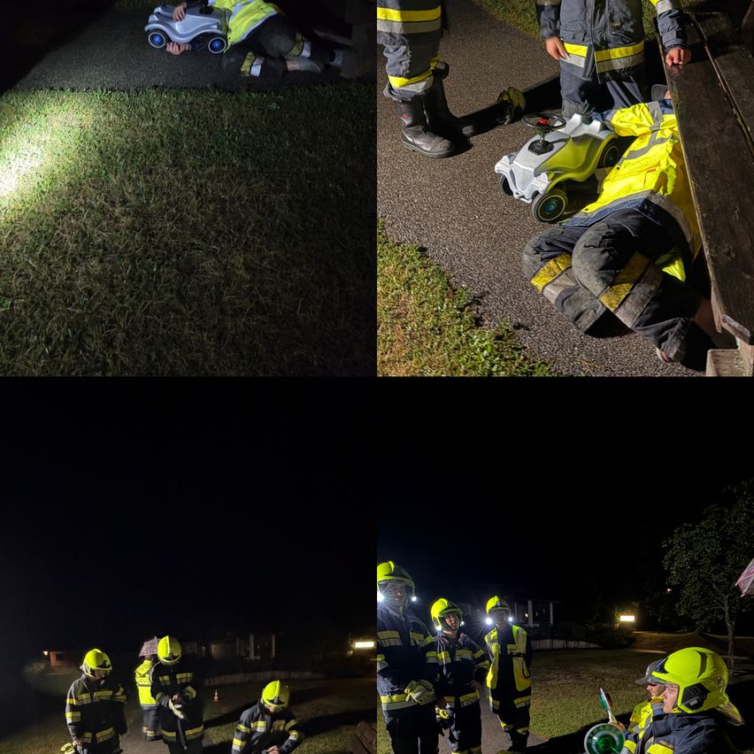 Eine nächtliche Szene mit Feuerwehrleuten in gelben und schwarzen Uniformen, einer liegt auf dem Boden und ein anderer steht mit einer Taschenlampe.