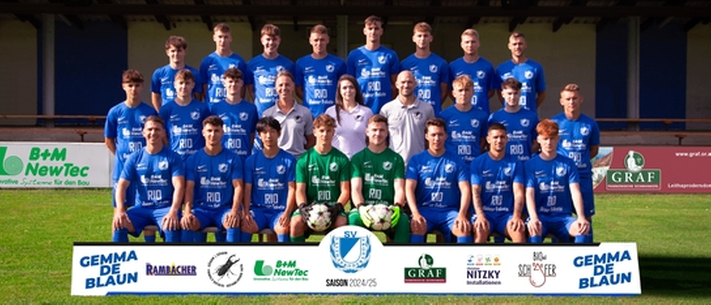 A soccer team wearing blue uniforms poses for a photo in front of a stadium with a large sign reading 'LeithA Arena.' Sponsors' logos appear at the bottom of the image.