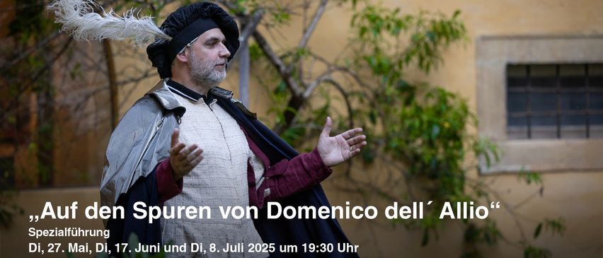 Ein Mann in historischer Kleidung steht draußen und gestikuliert mit beiden Händen. Ein Textüberlagerung lautet: Spuren von Domenico dell'Aluni und Di, 8. Juli 2025 um 19:30 Uhr.