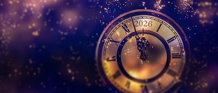 Eine Vintage-Uhr mit dem Jahr 2026, umgeben von einem Ausbruch goldener und blauer Lichter.