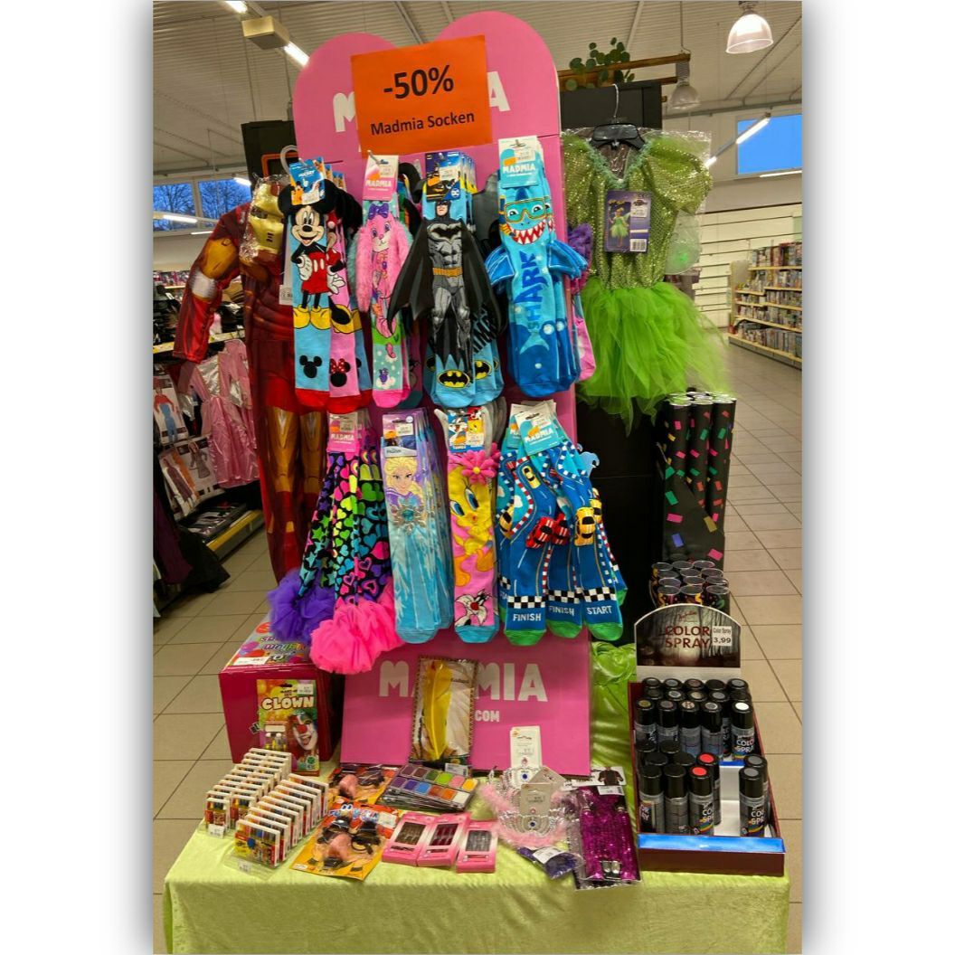 A store display featuring a colorful assortment of socks and accessories with a 50% discount sign.