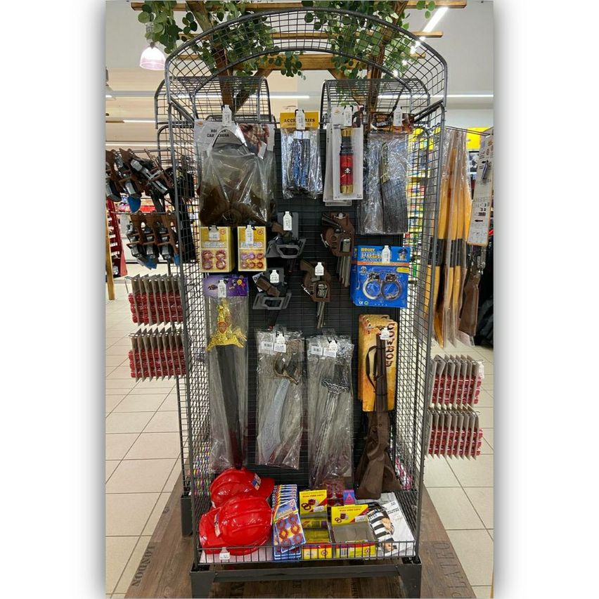 A store display featuring a variety of party supplies including red helmets, swords, and other novelty items.