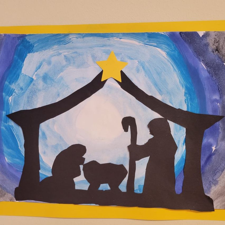 A watercolor painting depicts a nativity scene with a manger, a yellow star above, and silhouettes of Mary, Joseph, and the baby Jesus.