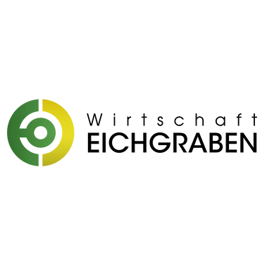 Ein kreisförmiges Logo mit grünen und gelben Farben auf schwarzem Hintergrund.