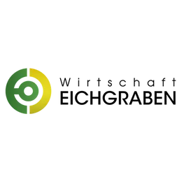 Ein kreisförmiges Logo mit grünem und gelbem Umriss, zentral auf schwarzem Hintergrund positioniert.