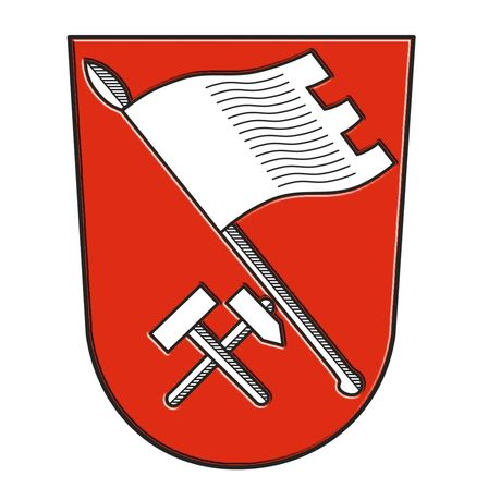 Ein roter Schild mit einer weißen Flagge und gekreuzten Hämmern auf weißem Hintergrund.