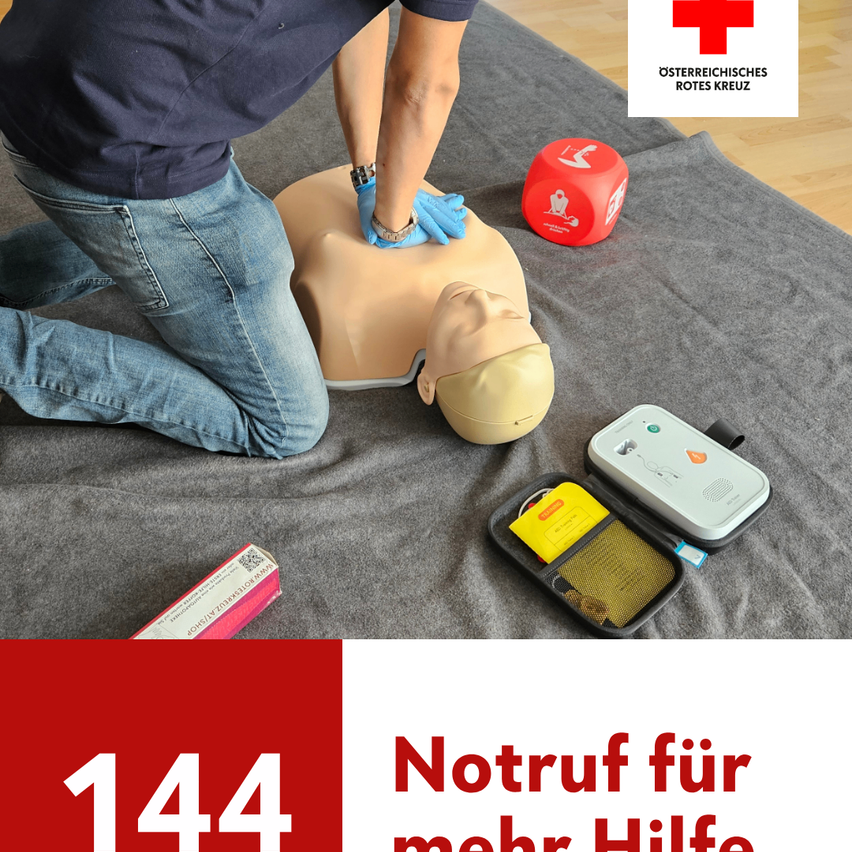 A person wearing gloves is performing CPR on a mannequin. A red dice, a first aid kit, and a red cross logo are on the floor. The number 144 is displayed prominently.