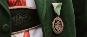 Coat, Formal Wear, Logo, Dress, Jacket, Badge, Symbol, Gown, Overcoat, Locket