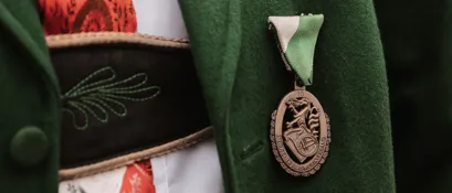 Coat, Formal Wear, Logo, Dress, Jacket, Badge, Symbol, Gown, Overcoat, Locket