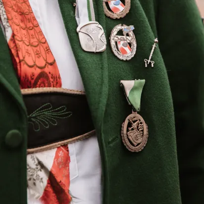 Coat, Formal Wear, Logo, Dress, Badge, Symbol, Jacket, Gown, Overcoat, Locket