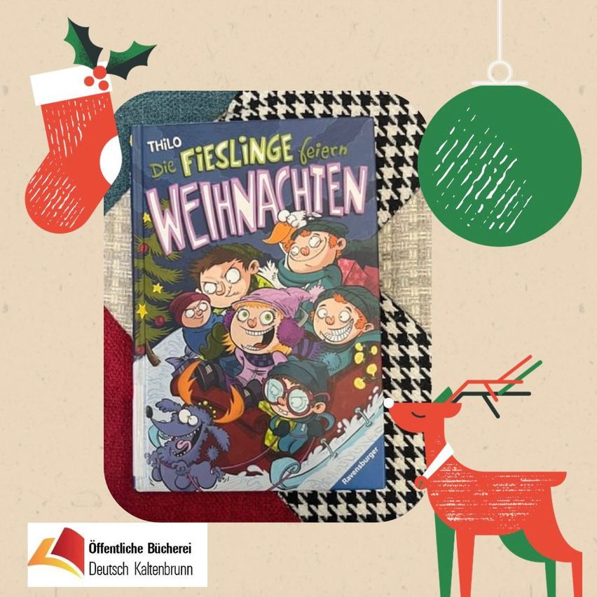 A festive book titled 'Die Fieslinge feiern Weihnachten' is placed on a table. It features a cartoon illustration of children enjoying a snowy Christmas.