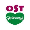 Das Logo von OST Steiermark ist auf weißem Hintergrund dargestellt. Es zeigt den Text 'OST' in Lila, der über einer grünen Herzform positioniert ist. Unter 'OST' steht der Wort 'Steiermark' in Weiß innerhalb des Herzens.