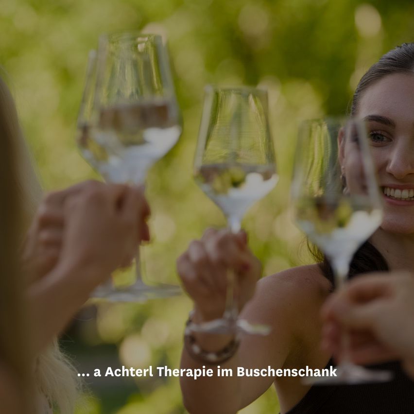 Several people holding wine glasses together outside, one woman smiling, blurry background.