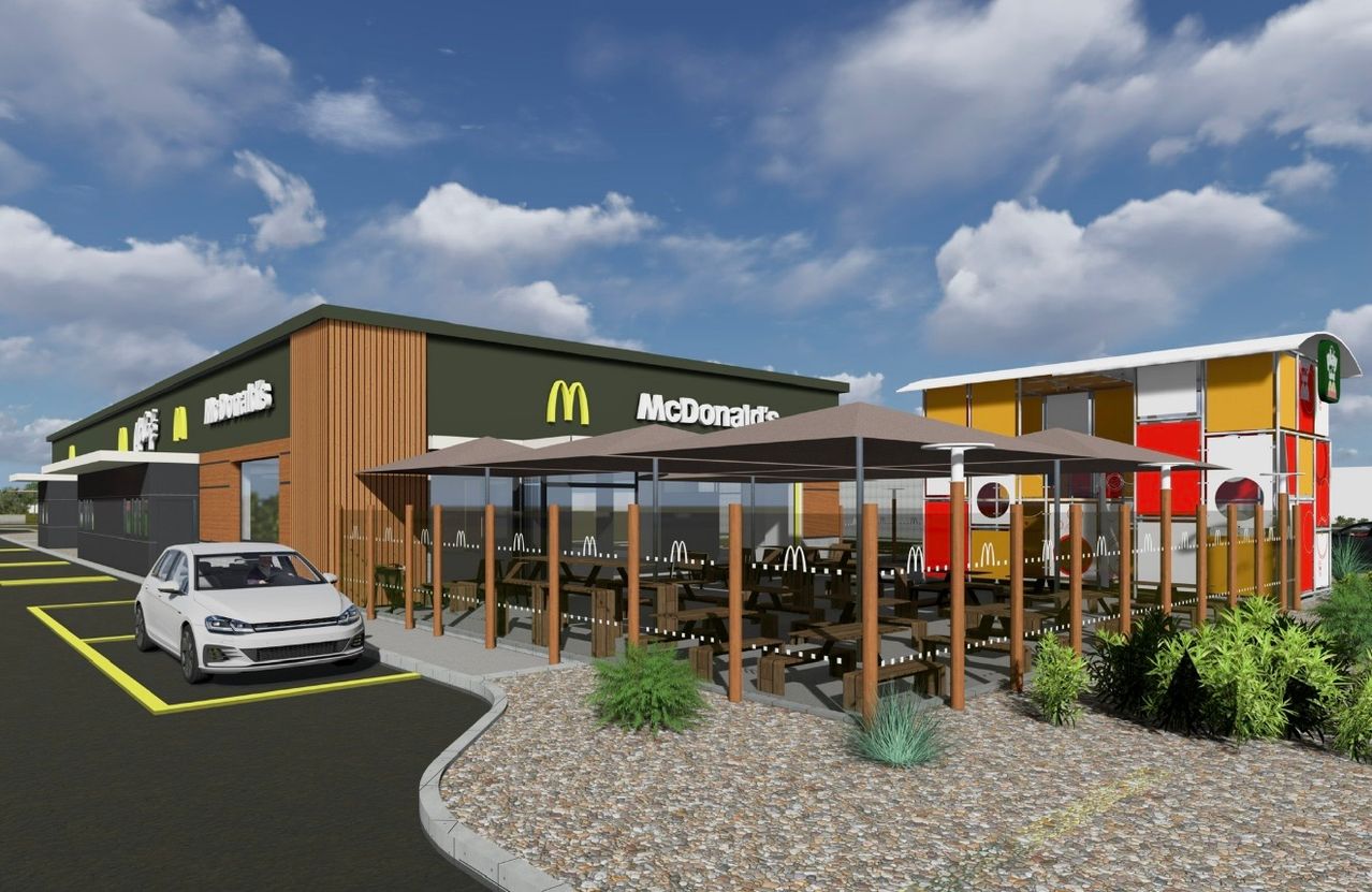 An artist's rendering of a McDonald's with outdoor seating and a car parked in front.