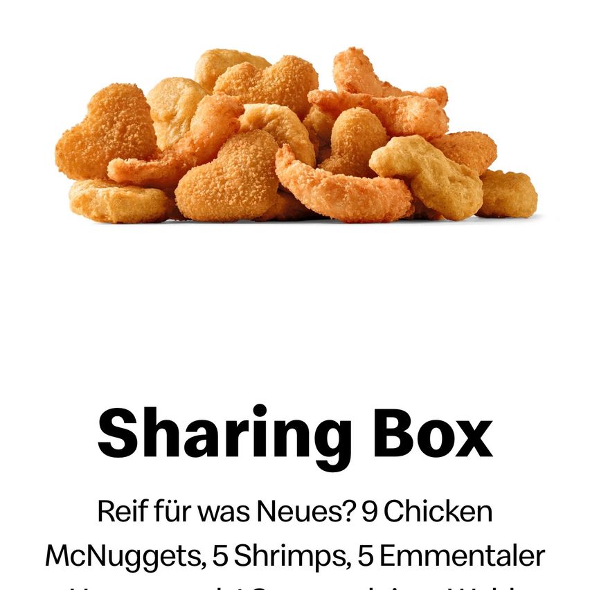 Ein Haufen gebratener Chicken Nuggets und Shrimps auf weißem Hintergrund. Der Text lautet 'Sharing Box' und 'Reif für was Neues? 9 Chicken McNuggets, 5 Shrimps, 5 Emmentaler'.