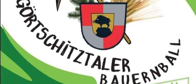Ein Plakat für Gortschitztaler Bauernball mit einem Schild, einem Bären, einer Sense und Weizen, umgeben von dem Text 'Gortschitztaler Bauernball' in einem grünen und weißen Farbverlauf.