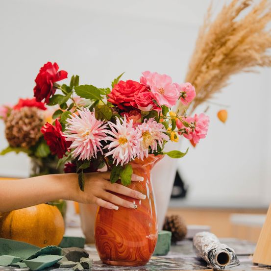 Image contains, Flower, Flower Arrangement, Plant, Flower Bouquet, Rose, Jar, Fruit, Orange, Produce, Person