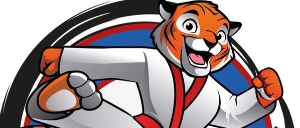Ein kreisförmiges Logo, das einen gezeichneten Tiger in einem Karate-Outfit mit einem roten Gürtel zeigt, der kickt und eine Faust zeigt, mit dem Text 'TIGER-KIDS' in weiß auf blauem Hintergrund.