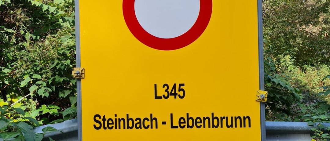 Bild enthält, Sign, Symbol, Advertisement, Plant, Vegetation, Road Sign, Mailbox