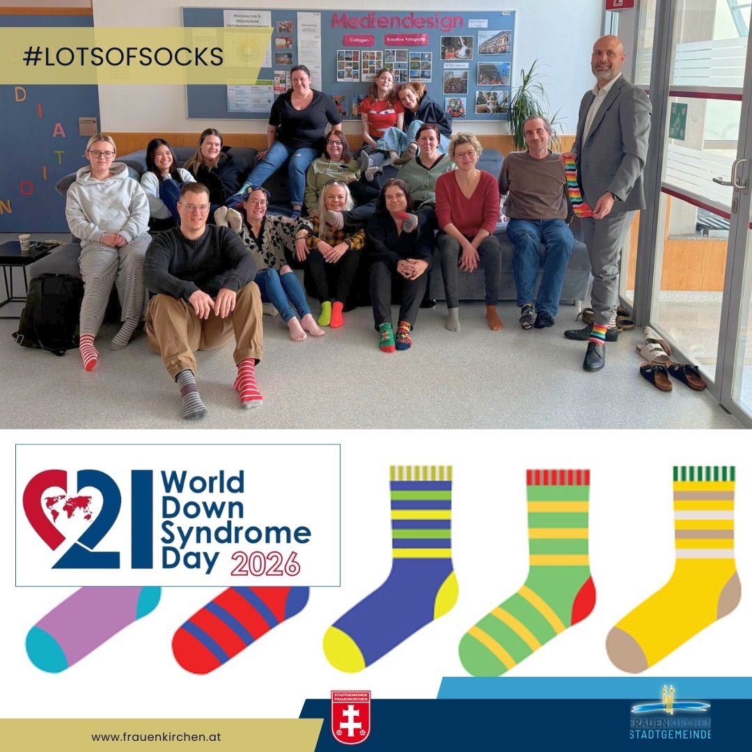 A group of people wearing colorful socks with the hashtag #LOTSOFSOCKS. They are posing for a photo in a room with a glass door. Below is a poster for World Down Syndrome Day 2026.
