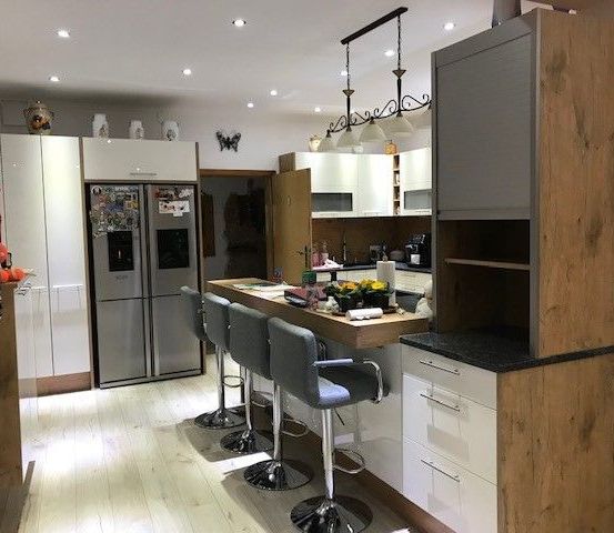 Bild enthält, Indoors, Kitchen, Interior Design, Appliance, Device, Electrical Device, Refrigerator, Person, Kitchen Island