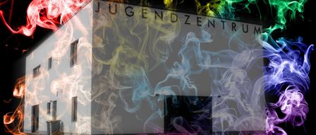 A building labeled Jugendzentrum with colorful smoke effects around it. The smoke is in various colors like red, yellow, green, and blue.