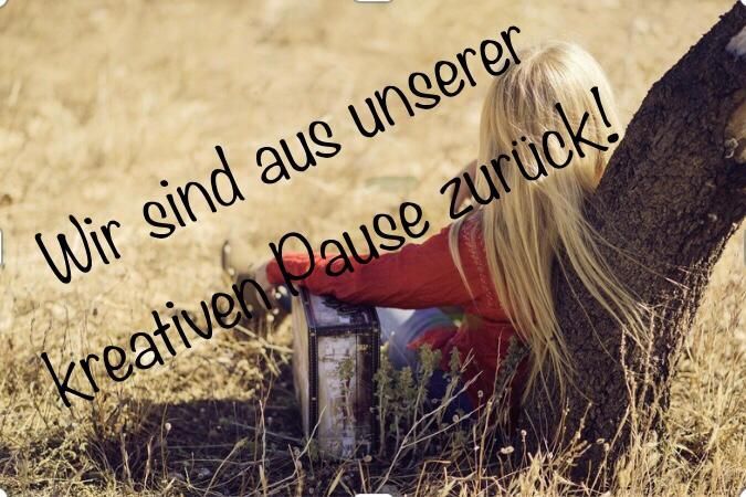 A blonde woman sits on the ground, leaning against a tree, holding a box. The text overlay reads 'We are taking a creative pause!' in German.