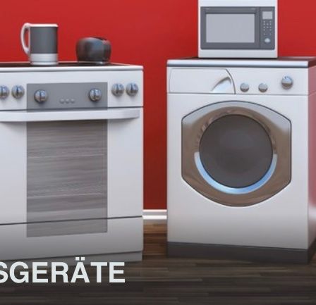 Eine Küche mit Herd, Mikrowelle und Wasserkocher. Daneben steht eine Waschmaschine, mit einem Staubsauger in der Nähe. Die Wand ist rot.