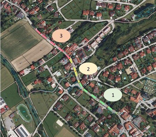 Luftaufnahme einer Stadt mit nummerierten Zonen, einer Hauptstraße, Wohngebieten und einem Teich. Zone 3 ist im Nordwesten, Zone 2 in der Mitte und Zone 1 im Südosten.