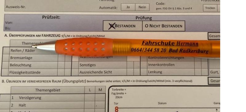 A German vehicle inspection report with personal details, vehicle data, and inspection results. A pen rests on the report, and a visual aid depicts braking distances.