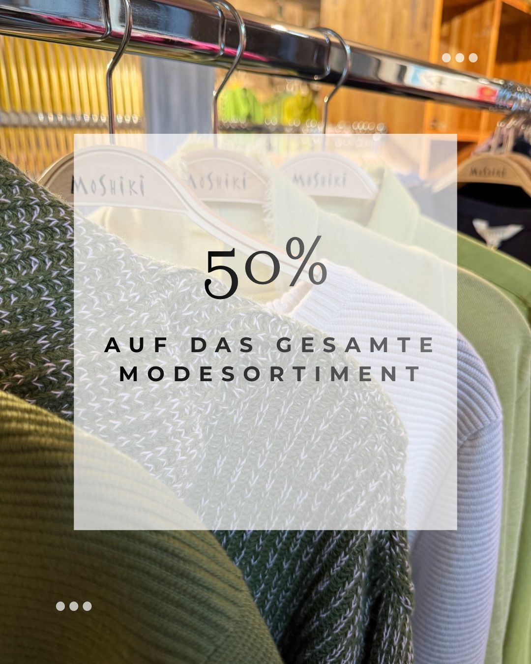 Clothes hanging on a rack with text overlay reading 50% off the entire fashion range.