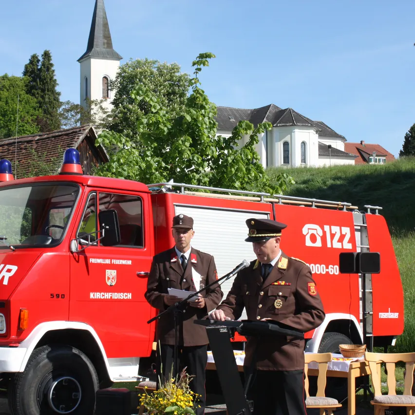 Chair, Adult, Male, Man, Person, Hat, Tie, Vehicle, Gun, Fire Truck