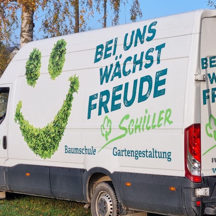 A white van with a smiling leaf logo and the words 'Bei uns wächst Freude' is parked on a grassy field with trees in the background.