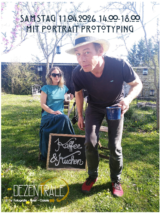 A man and a woman are outside with a blackboard. The man holds a blue cup and wears a hat. The woman wears sunglasses and a blue dress. There is a sign with a date and time on the top left.