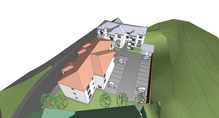 Eine 3D-Darstellung eines Wohnkomplexes mit mehreren Gebäuden, darunter ein Haupthaus mit rotem Dach und einem Parkplatz mit mehreren geparkten Autos. Der Komplex ist von Bäumen und Grünflächen umgeben.
